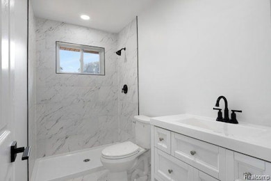 Bathroom with vanity, a shower stall, and marble finish floors