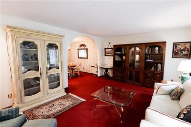 Carpeted living room featuring a textured ceiling