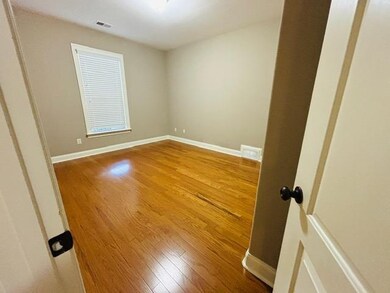 Spare room with wood finished floors and baseboards
