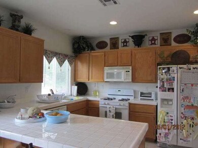 Kitchen opens up into the family room...canned lig