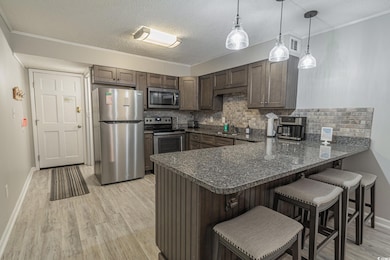 Kitchen featuring light wood-style flooring, stain