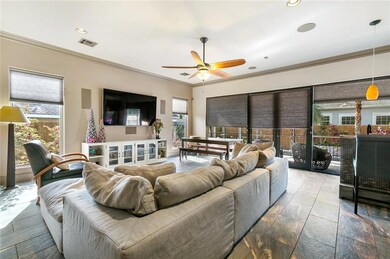 Wall of windows in living area overlooking backyar