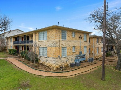 Rear view of property with a balcony, a yard, bri