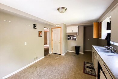 Kitchen featuring light countertops and light carp