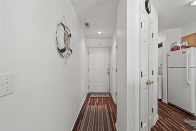 Hallway with dark hardwood / wood-style floors and