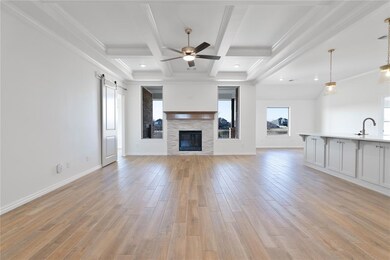 Unfurnished living room featuring coffered ceiling