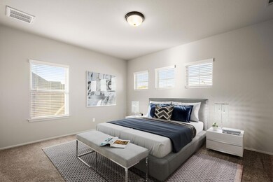 Carpeted bedroom with baseboards and visible vents