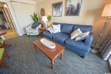 Carpeted living room with ornamental molding