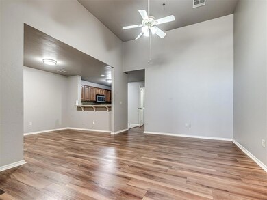 Unfurnished living room with high vaulted ceiling,