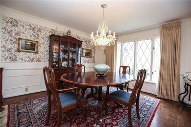 Spacious Dining Room with detailed wainscoting.