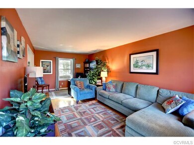 Large family room with warm hardwoods and plenty o