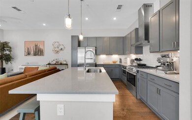 Kitchen with stainless steel appliances, wall chi