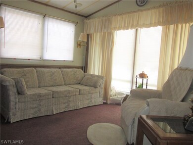 Living room w/windows on right to front of house.