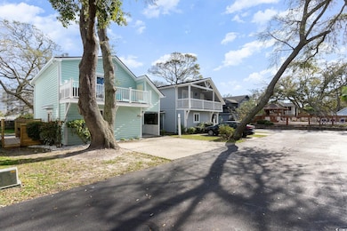 View of front facade featuring a residential view and concrete driveway