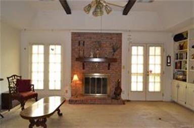 Tall windows and French doors to the patio provide