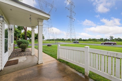 At the front entrance is a private screened patio.