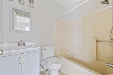 Bathroom featuring toilet, wood finished floors, v