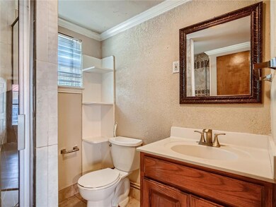 Bathroom with vanity, baseboards, ornamental mold