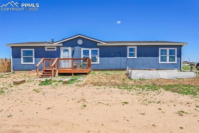 Rear view of house with a wooden deck and fence