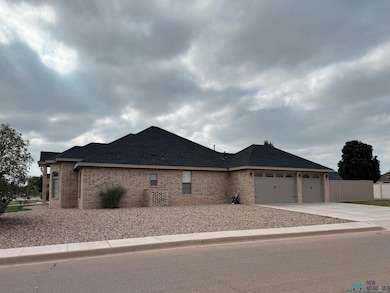 View of front of house featuring brick siding, driveway, an attached garage, and a shingled roof