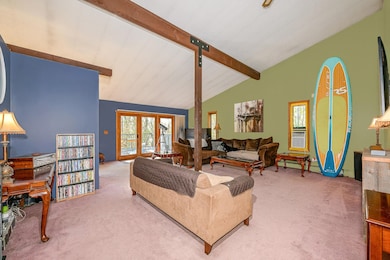 Living room featuring beamed ceiling, carpet, a baseboard heating unit, french doors, and high vaulted ceiling
