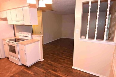 Kitchen featuring electric stove, light counterto