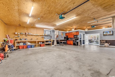 Garage with a workshop area, wood ceiling, and a g