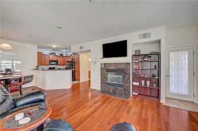 Living room with light wood-style floors and a til