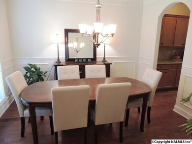 Arched Doorways accented by detailed trim work & crown molding-hand scraped wood floors