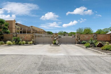 View of road featuring a gated entry, a gate, and