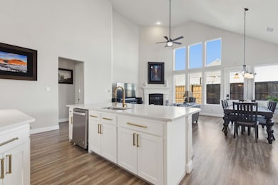 Kitchen featuring a seated island with sink, dishw