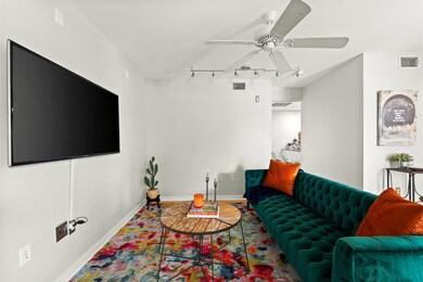 Living room featuring rail lighting and ceiling f