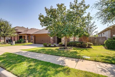 View of front of home with a front yard and a gara