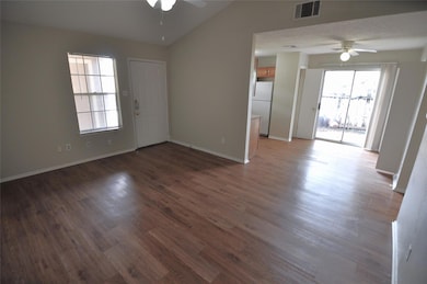 Empty room featuring a ceiling fan, lofted ceilin
