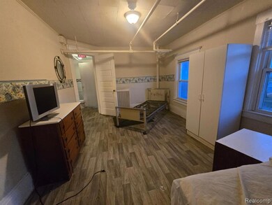 Bedroom with dark wood-style floors