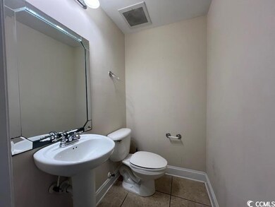 Bathroom featuring tile patterned flooring and toi