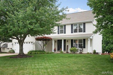 View of front of property with a porch, driveway, a front yard, and roof with shingles