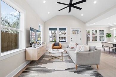 Soaring ceilings elevate the living space, complem