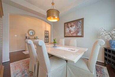 Delving further into the home reveals a spacious dining room adorned with an elegant lighting fixture, adding a touch of refinement to the space. The combination of ample room and tasteful lighting creates an inviting atmosphere, perfect for hosting memorable gatherings and intimate meals with loved ones.