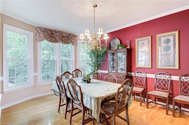 Dining area just right off the living room features crown and chair rail moulding, lots of windows, and wood flooring.