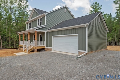 View of front of property with covered porch, gravel driveway, a garage, roof with shingles, and board and batten siding