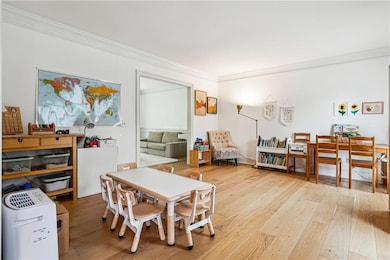 Dining area featuring crown molding and hardwood /