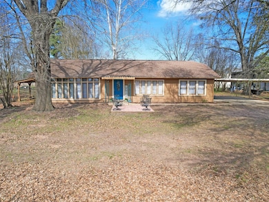 Rear view of property featuring a carport