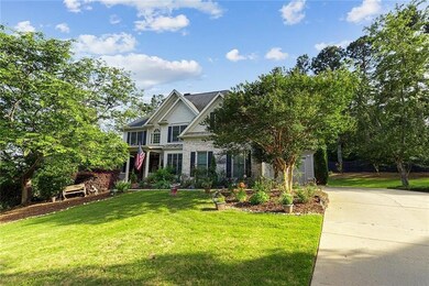 View of front facade featuring a front lawn and driveway