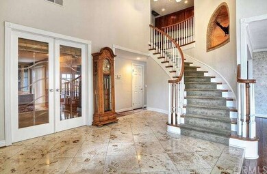 Foyer Showcasing a Dramatic Curving Staircase, Tra