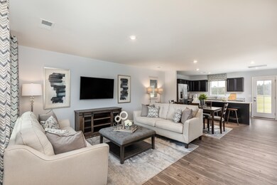 Beautiful open concept layout with a spacious family room, kitchen, and dining room!  *Model Photo for reference*