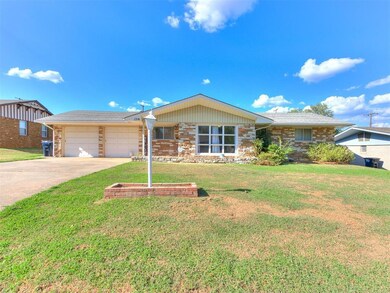 Ranch-style home with a garage and a front lawn