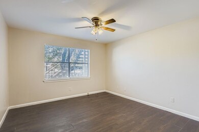 Spare room featuring dark wood-type flooring and a ceiling fan