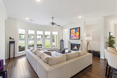 Gather the family and guests together in your lovely living room! Featuring recessed lighting, dark stained ceiling fan with lighting, custom paint, gorgeous wood floors, fireplace with mantel and large windows that provide plenty of natural lighting throughout the day.
