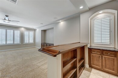 Hallway with baseboards, visible vents, light colo